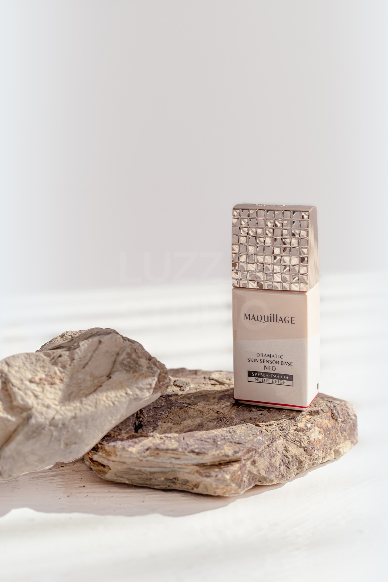 石の上に化粧品を配置して、天然素材のぬくもりとコントラストを演出した商品撮影